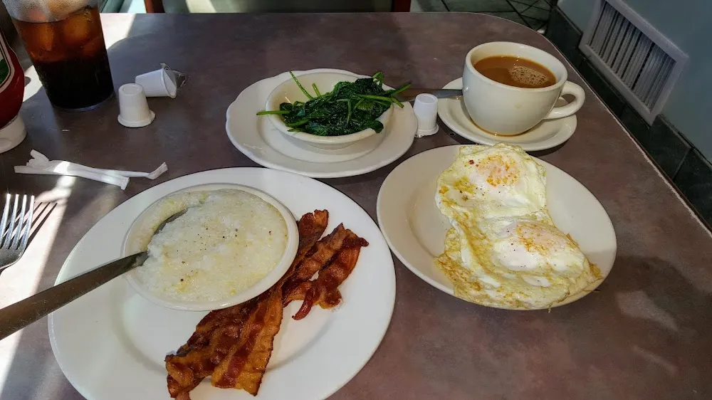 The Jacque Howard 2 Eggs over Med Bacon Grits Side of Sauteed Spinach
